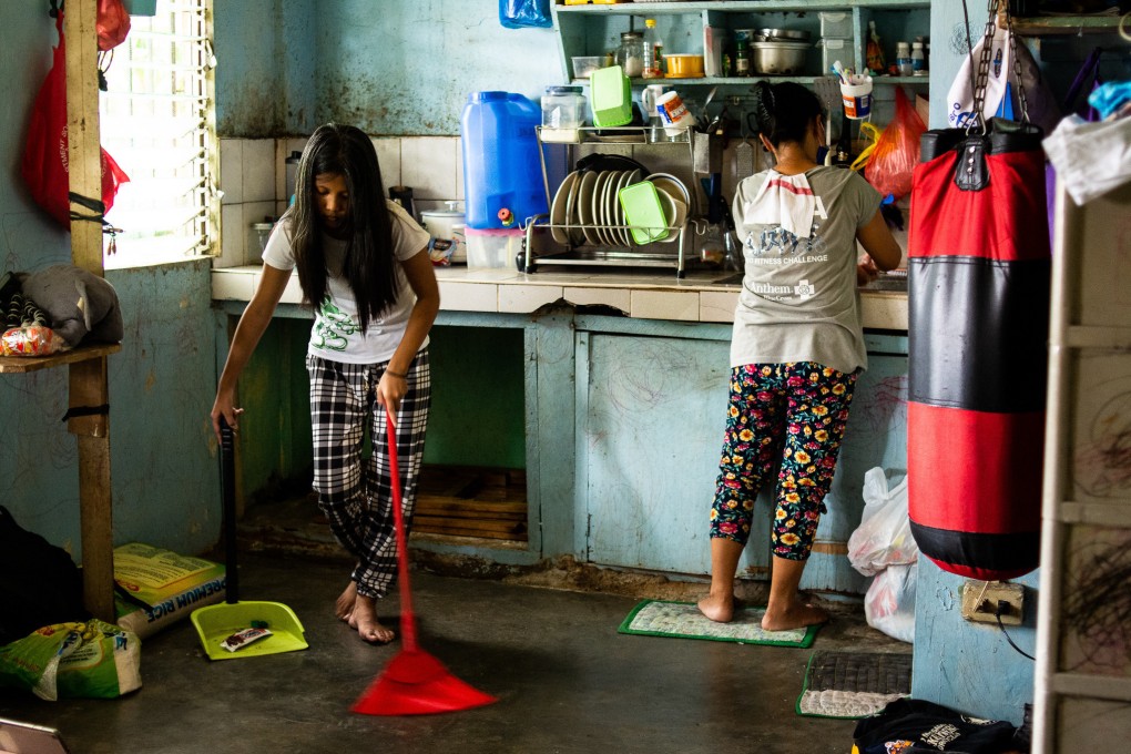 Jasmine, 17 this month, sweeps the floor in her family’s village home. She has a lot of other chores to do too. Photo: Maro Enriquez
