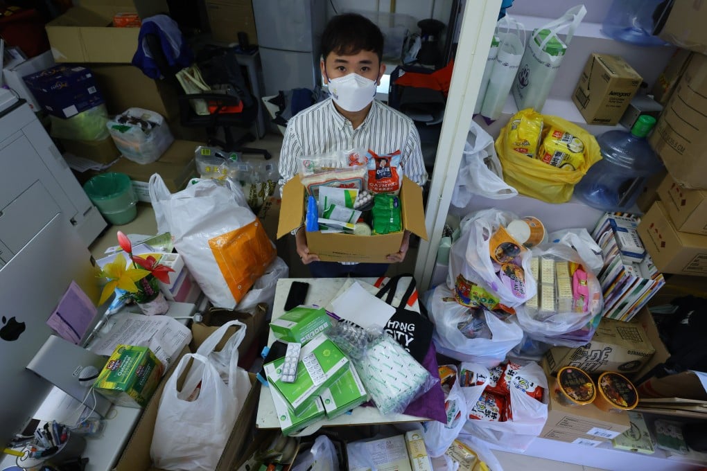District councillor Chris Mak sorts out piles of Covid-19 supplies for residents at his office in Ma On Shan. Photo: Dickson Lee
