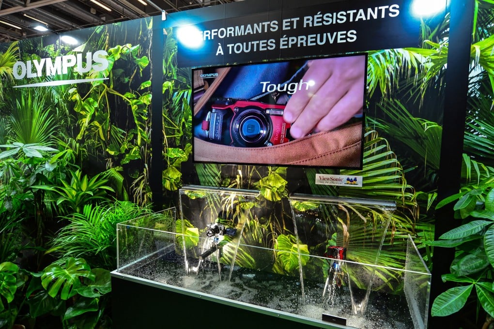 Olympus advertises its new waterproof camera, the Tough TG-6 - this camera can go in the sea and take pictures and video even in freezing temperatures - at a trade fair in Paris. Photo: Getty Images
