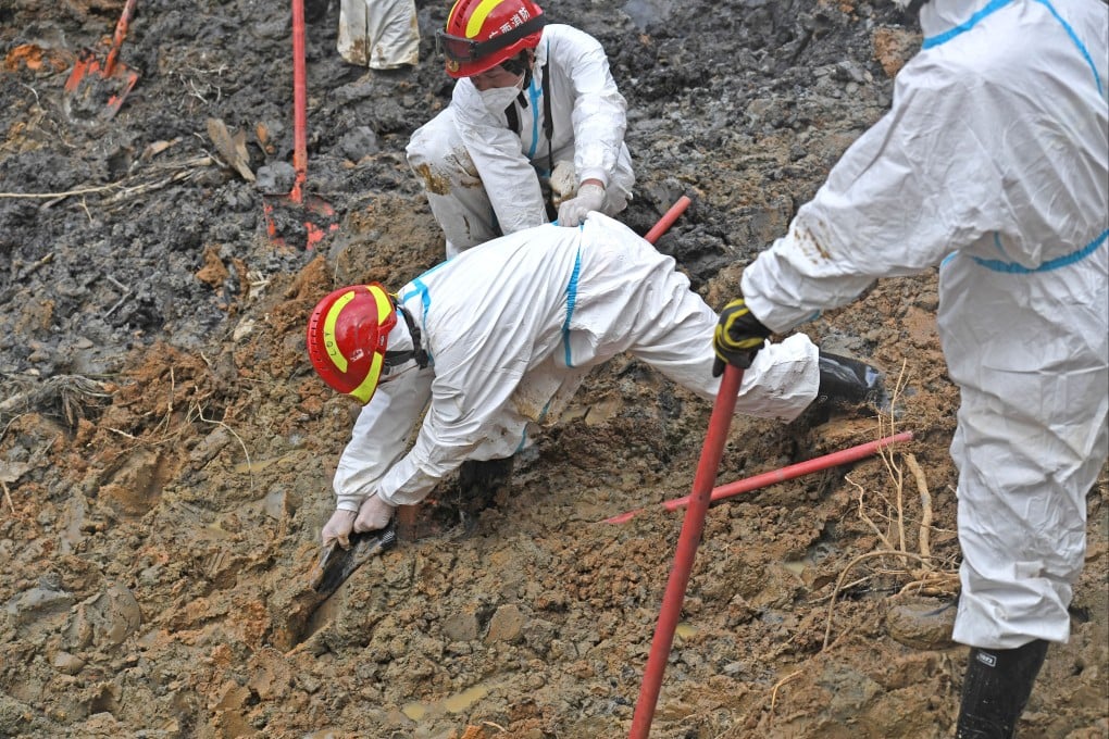 A rescuer tries to free a shoe stuck in the mud at the core site of a plane crash in Teng county in the Guangxi Zhuang Autonomous Region on Friday. Photo: Xinhua