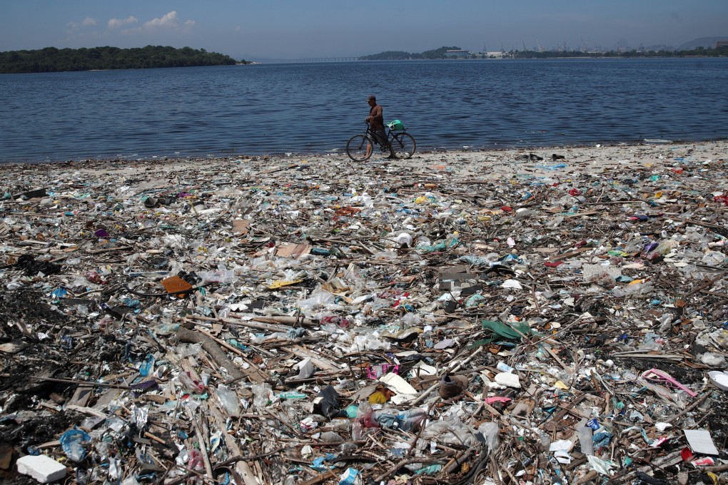 A man walks past garbage at a polluted beach on the banks of Guanabara Bay in Rio de Janeiro, Brazil on March 16. Photo: Reuters