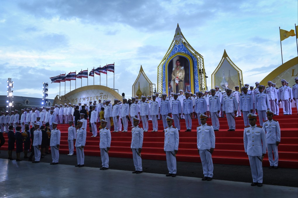 Thai Royal Army officers stand to attention in front of a portrait of the King of Thailand Maha Vajiralongkorn. Photo: AFP