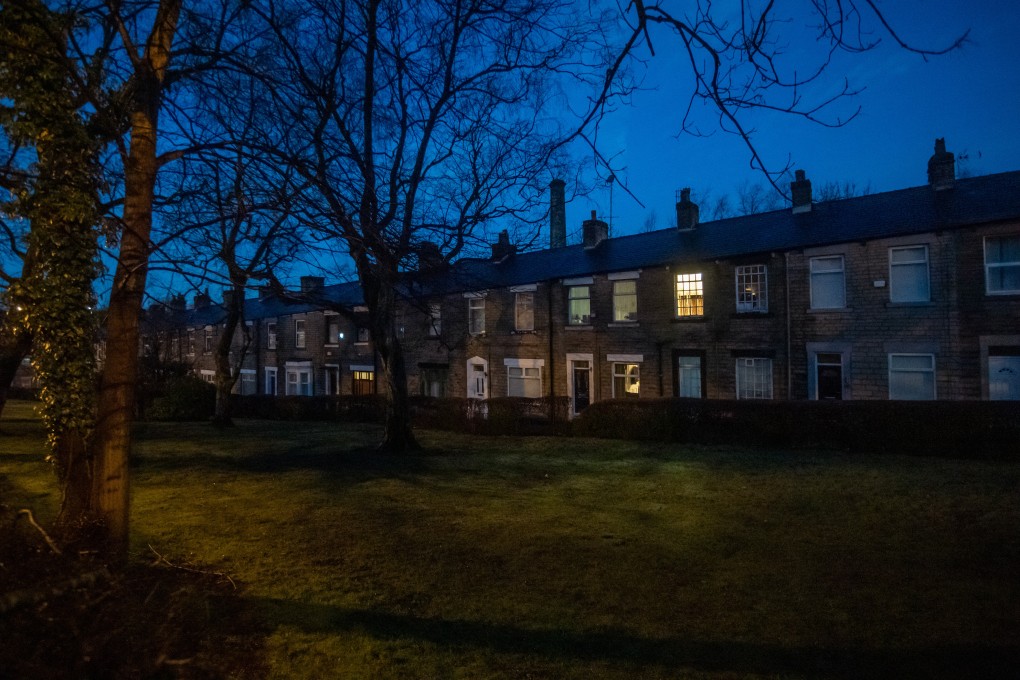 Lights on in a row of terraced houses in northern Britain. The nation’s energy grid is moving towards more electricity rather than gas. Photo: Bloomberg