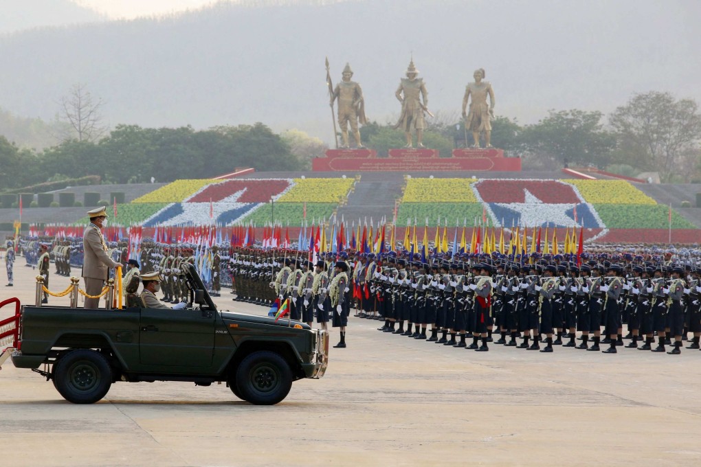 Myanmar junta chief Senior General Min Aung Hlaing stands in a vehicle at a ceremony to mark Armed Forces Day in Naypyidaw on Sunday. Photo: AFP