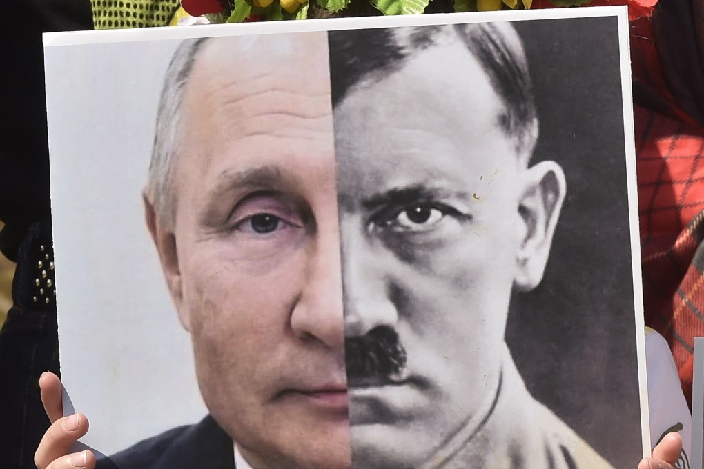 A Ukrainian girl carries a placard showing the Russian leader Vladimir Putin and World War Two Nazi leader Adolf Hitler during a protest against Russia’s invasion of Ukraine in Lebanon on Sunday. Photo: EPA-EFE