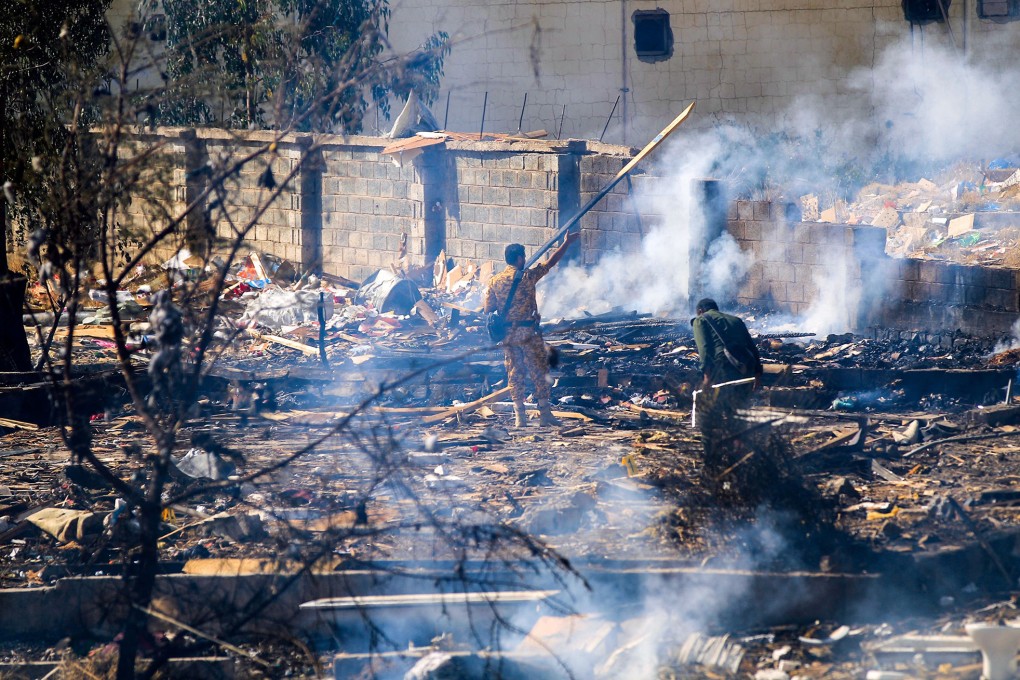 Yemenis assess the damage following overnight air strikes by the Saudi-led coalition targeting the Houthi rebel-held capital of Sanaa on Saturday. Photo: Mohammed Huwais/AFP/Getty Images/TNS