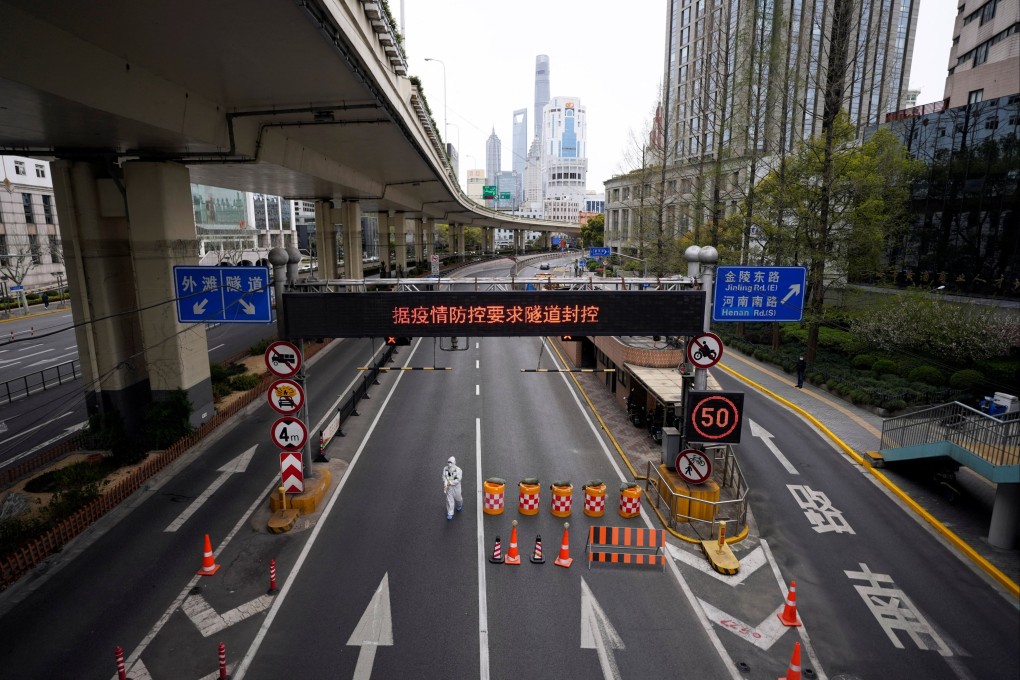 A worker in a protective suit walks along a Shanghai highway, amid Covid restrictions. Photo: Reuters