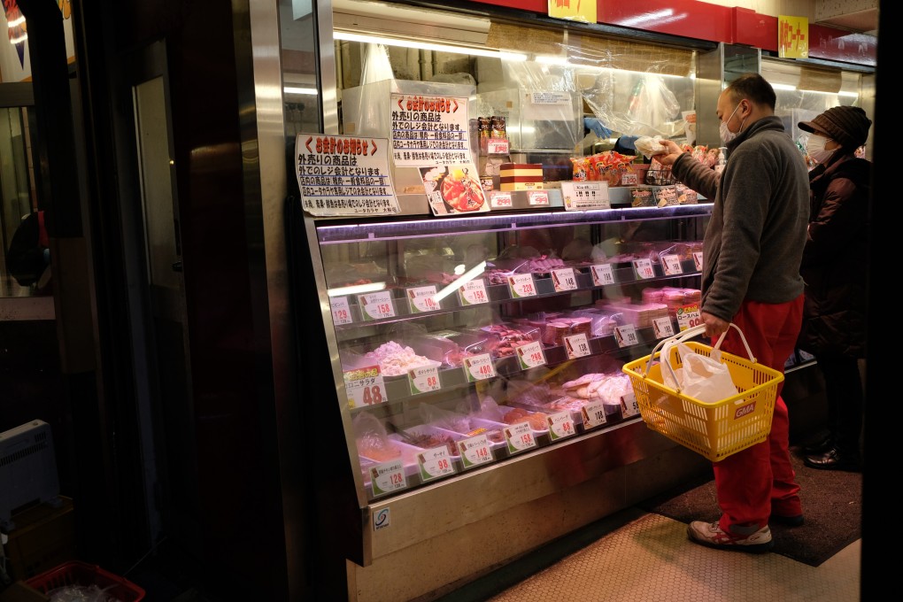 A shopper purchases meat at a store in Kamakura, in Kanagawa Prefecture, Japan, on February 11. Prices are rising in Japan, but unlike inflation seen in many other places, the increases are long-sought and unlikely to last, analysts say. Photo: Bloomberg