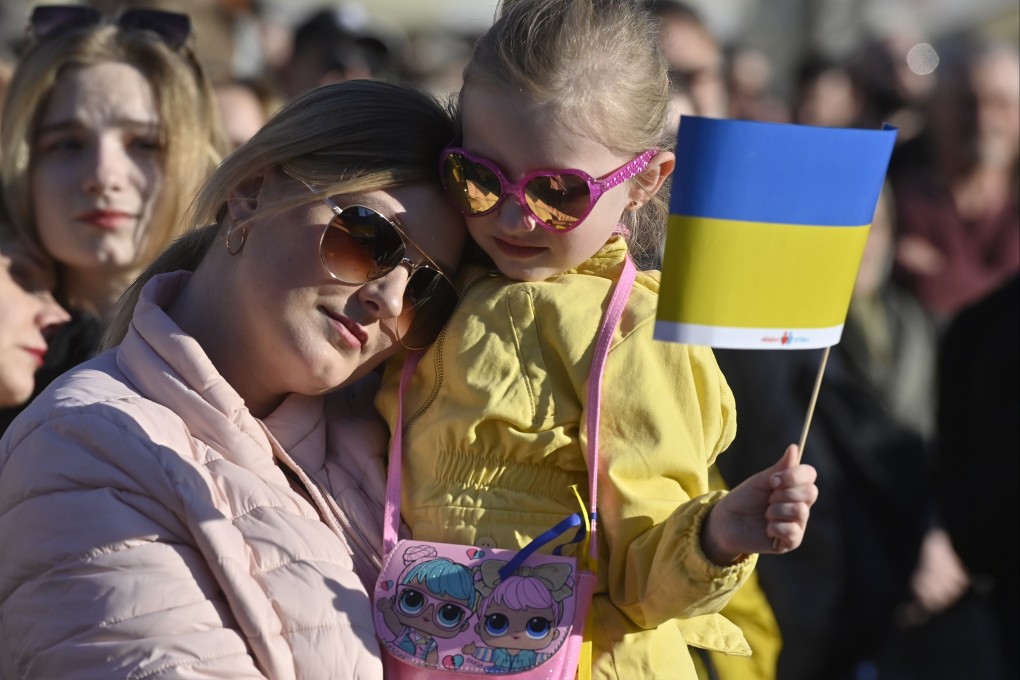 A woman and her daughter watch the streaming of benefit concert Save Ukraine – #StopWar at Prague’s Old Town Square in Czech Republic. Photo: CTK / DPA