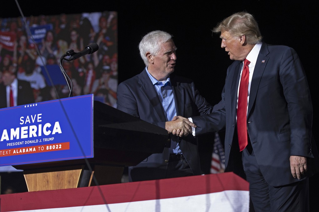 Former US president Donald Trump (right) welcomes congressional candidate Mo Brooks to the stage during a rally at York Family Farms in Cullman, Alabama, on August 21, 2021. Photo: TNS