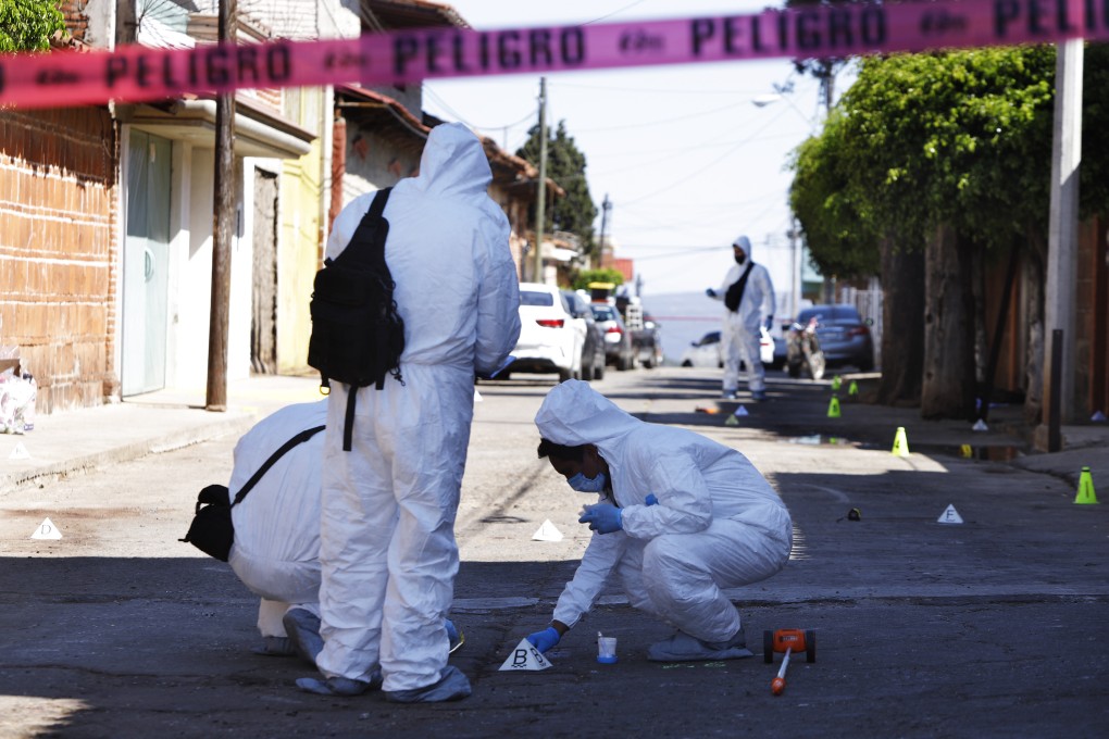 Investigators comb another crime scene in Mexico. The country has had around 340,000 murders since 2006. File photo: AP