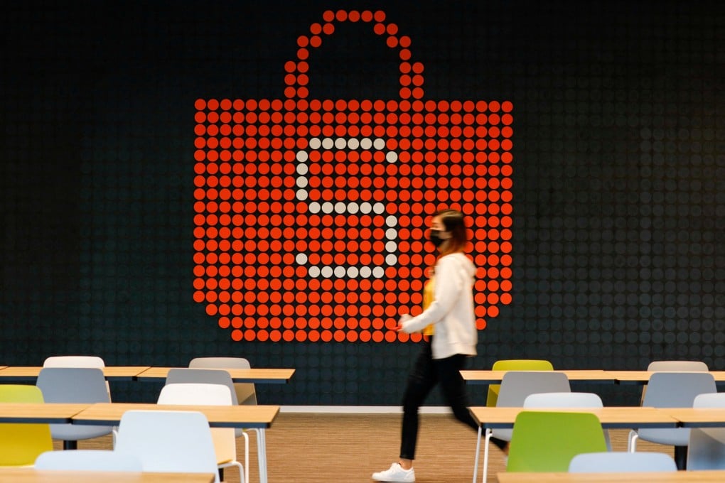 A person walks in front of a sign of Shopee, the e-commerce arm of Southeast Asia’s Sea, at its office in Singapore on March 5, 2021. Photo: Reuters
