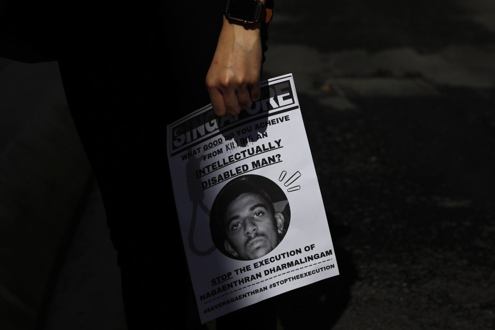 An activist in Kuala Lumpur holds a poster of Nagaenthran K. Dharmalingam, whose appeal against execution in Singapore for drug trafficking has been rejected. Photo: EPA