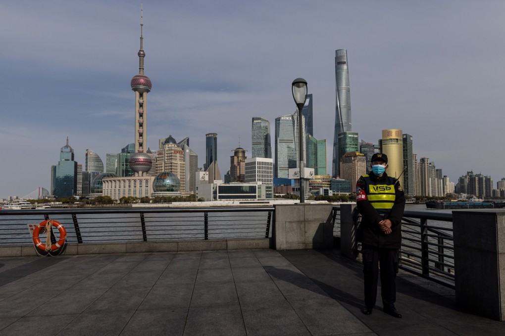 A police officer stands guard on the Bund, with Shanghai’s main financial district of Pudong in the background. Photo: EPA-EFE