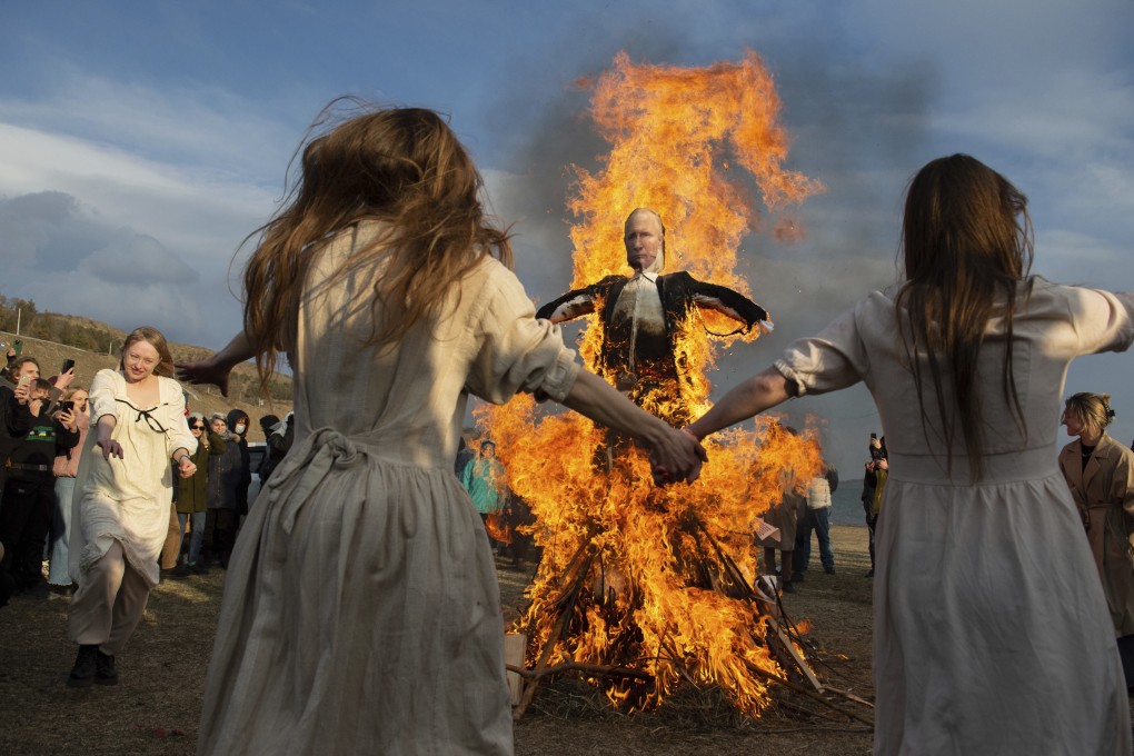 Demonstrators dance around a burning effigy of Russia’s President Vladimir Putin in Tbilisi, Georgia, on March 27. Photo: AP