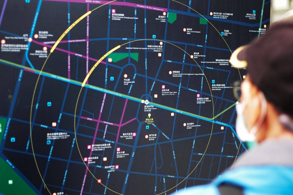 A man checks a map of Taipei at Ximen district in the city on March 29, 2022. Photo: AFP