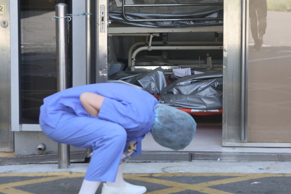 A nurse inspects bodies at Queen Elizabeth Hospital earlier this month. Photo: Jelly Tse