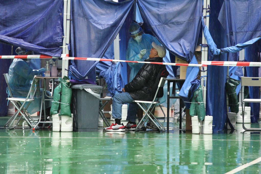 A resident gets a Covid-19 test on a rainy day at a mobile specimen collection station in the MacPherson playground in Mong Kok on March 28. Photo: Yik Yeung -man