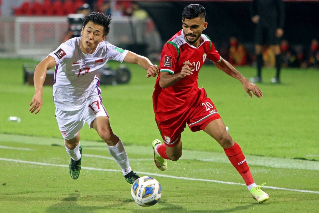 China’s Dai Wai-tsun (left) and Oman’s Salaah al-Yahyaei battle for the ball during their 2022 Qatar World Cup Asian Qualifiers match at the Sultan Qaboos Sports Complex. Photo: AFP