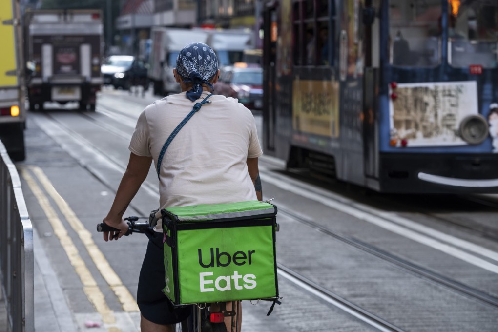 A delivery worker from Uber Eats, the ride-hailing giant’s take-out arm, is seen riding on a bicycle in Hong Kong on December 30, 2021. Photo: Anadolu Agency via Getty Images