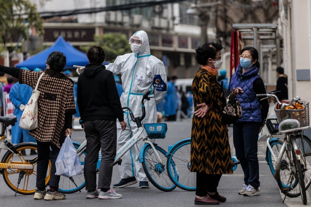 A police officer in protective gear blocks a Shanghai street where food rations are distributed. Photo: EPA-EFE