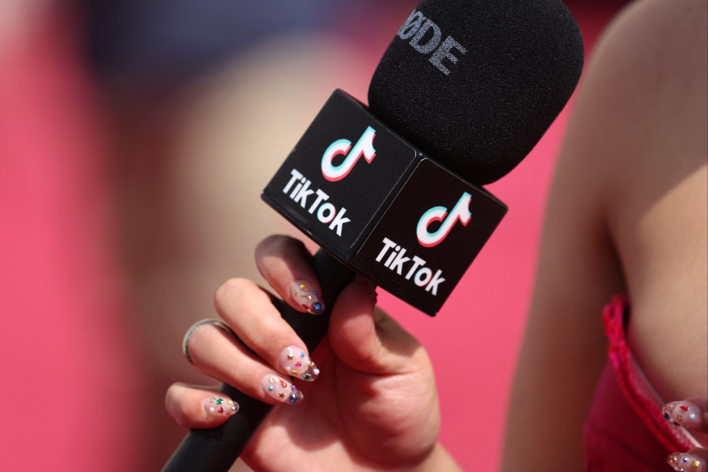 A social influencer talks into a TikTok microphone on the red carpet during the Oscars arrivals at the 94th Academy Awards in Hollywood, Los Angeles on March 27. Photo: Reuters
