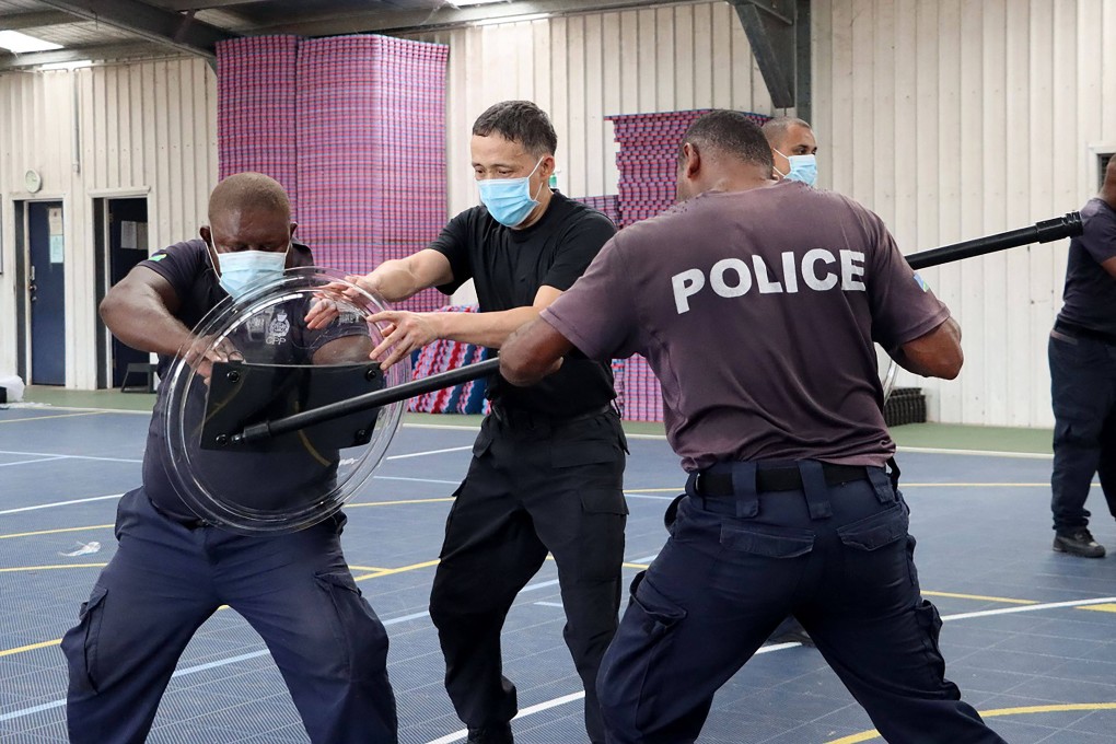 A police officer from China trains Solomon Islands officers. The two nations have agreed to a wide-ranging security pact. Photo: AFP