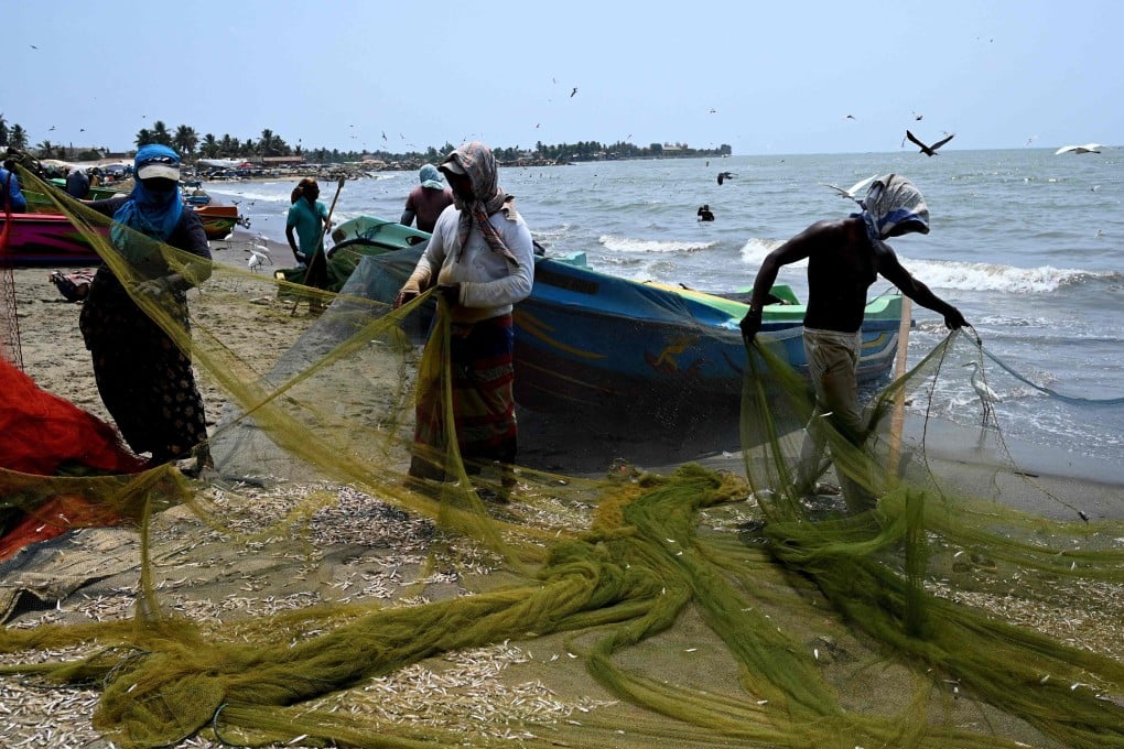 Fishermen at a fishery harbour in Negombo on March 24, 2022. Photo: AFP