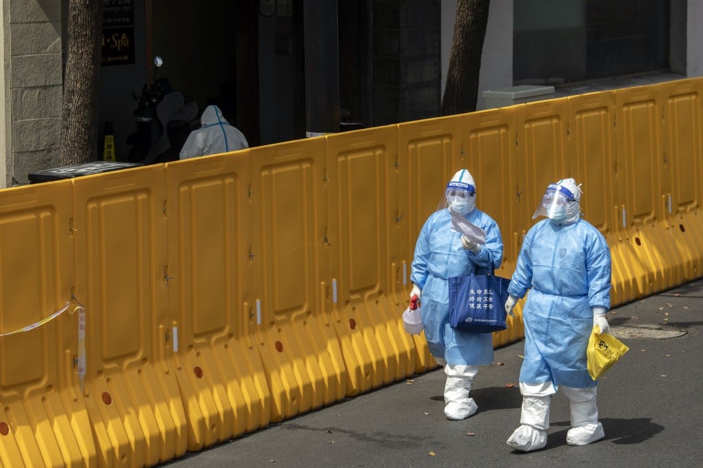 Workers in a neighbourhood under lockdown in Shanghai. There is growing discontent over the response to the latest wave of infections. Photo: Bloomberg
