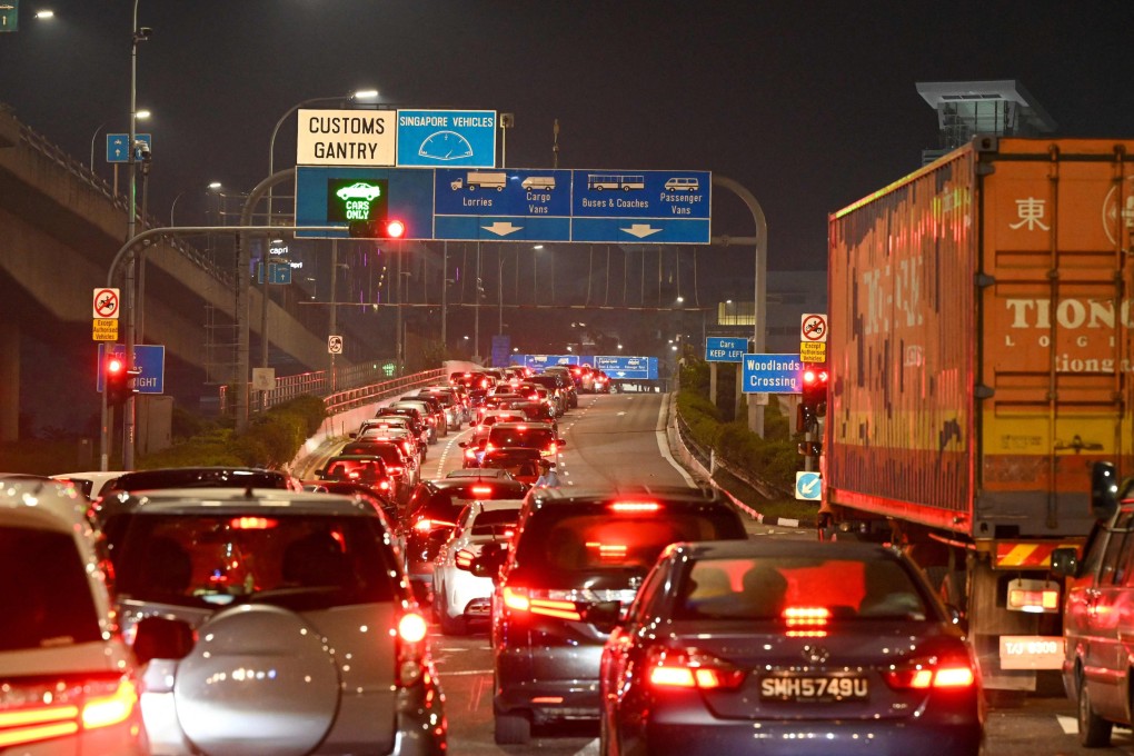 Vehicles form a long queue to enter the Woodlands Checkpoint in Singapore on April 1. Photo: AFP