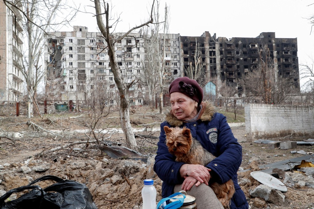 Mariupol resident Raisa Isulina, 73, seeks refuge in a damaged children’s home with her dog, Sonya, on Friday. Photo: Reuters