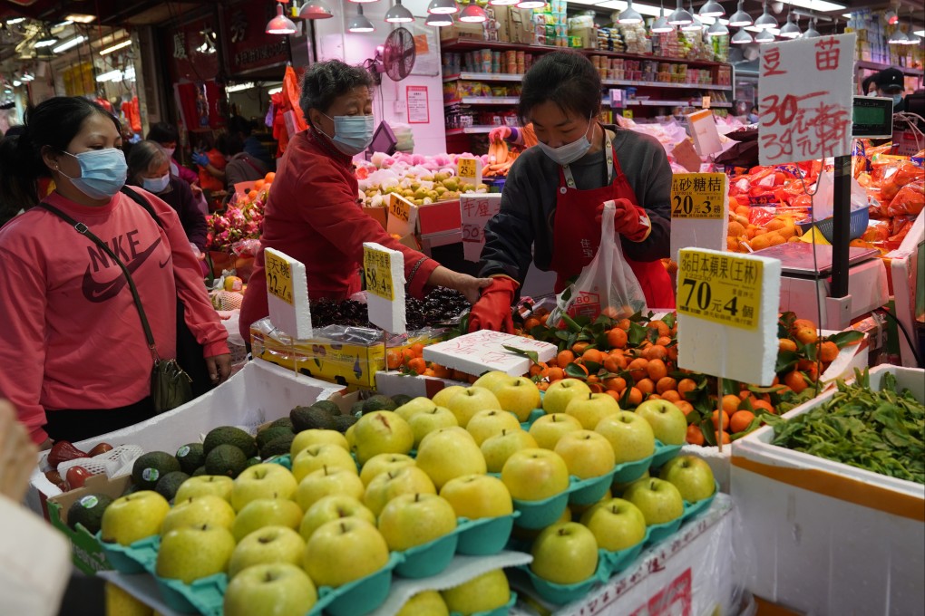 People buy vegetables and fruit at a wet market in North Point, Hong Kong. Photo: SCMP/Sam Tsang