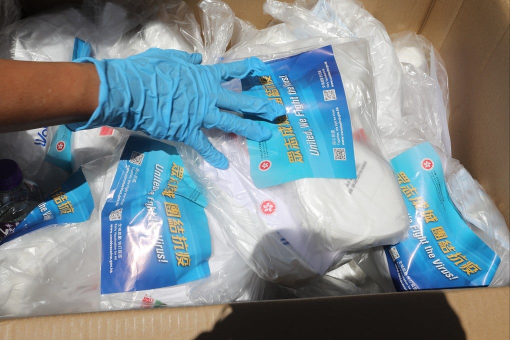 Volunteers distribute anti-epidemic packages to households across the city. Photo: Jelly Tse