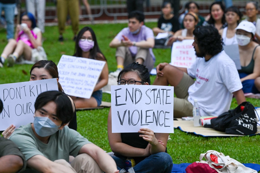 Attendees hold signs during a protest against the death penalty in Singapore. Photo: AFP
