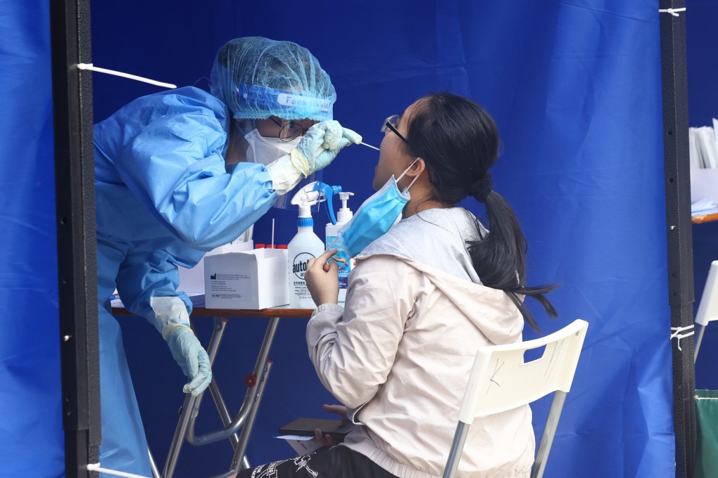 A resident of Lee Yat House at Shun Lee Estate undergoes Covid-19 testing on March 14 after the complex was put under lockdown and ordered to do mandatory testing. Photo: Dickson Lee