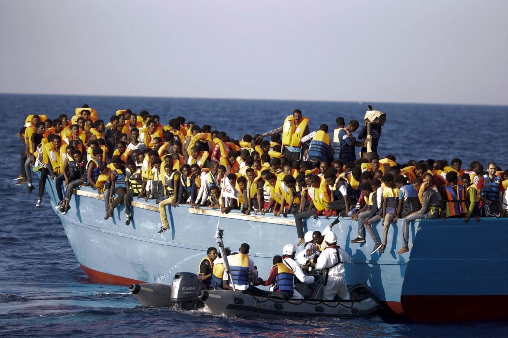 A crowded wooden boat in the Mediterranean sea about 13 miles north of Libya, back in 2018. Photo: AP
