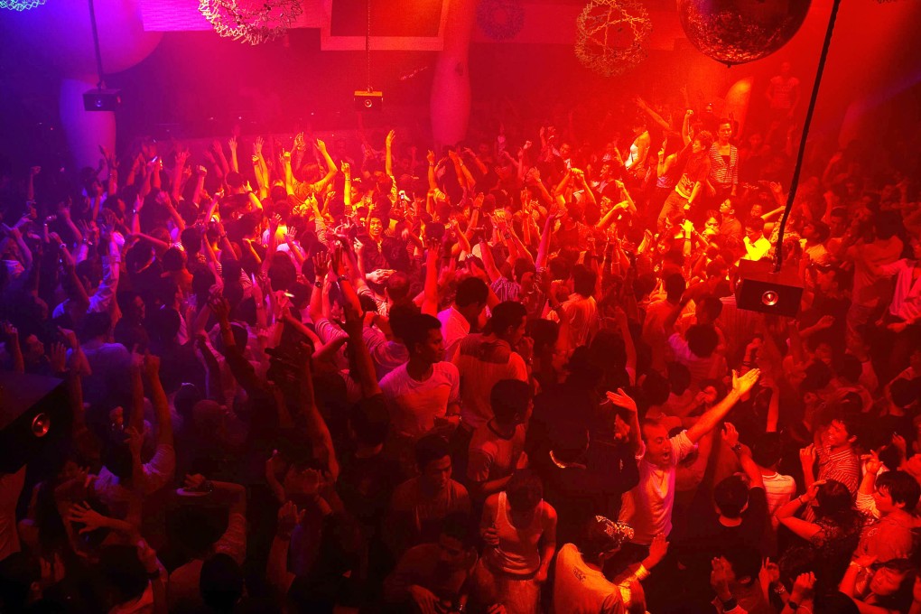 People dancing at a disco in Singapore before the pandemic. Nightclubs are due to open again on April 19 as the government eases restrictions. File photo: AFP