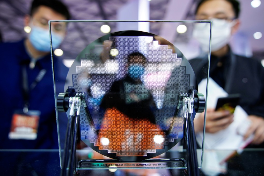 Visitors look at a semiconductor device on display at a trade fair in Shanghai in March 2021. The UK is keen to expand its presence in the chip manufacturing sector. Photo: Reuters