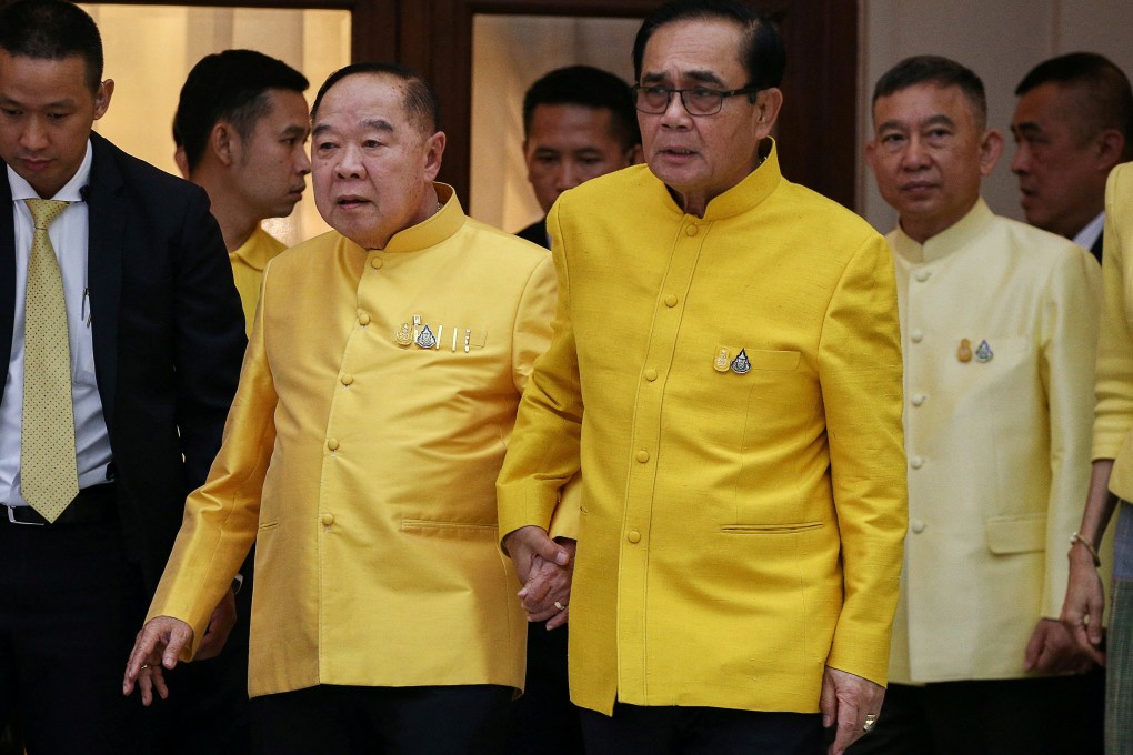 Thai PM Prayuth Chan-ocha holds hands with Deputy PM and Defence Minister Prawit Wongsuwan as they take part in water-pouring blessing on April 11, 2019. Photo: Reuters