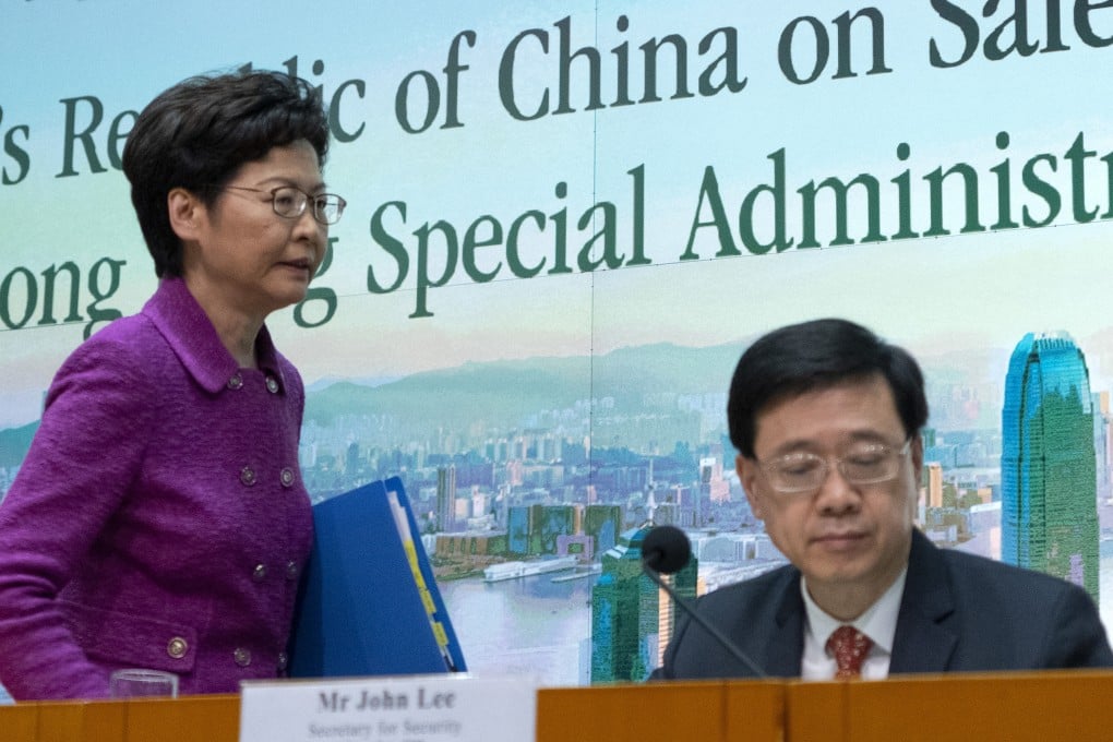 Hong Kong Chief Executive Carrie Lam stands next to No 2 official John Lee. Photo: Robert Ng