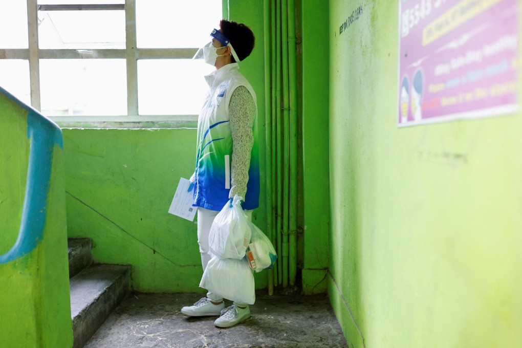 A volunteer delivers anti-epidemic packages containing rapid test kits to residents in Hong Kong on April 2. Photo: Reuters