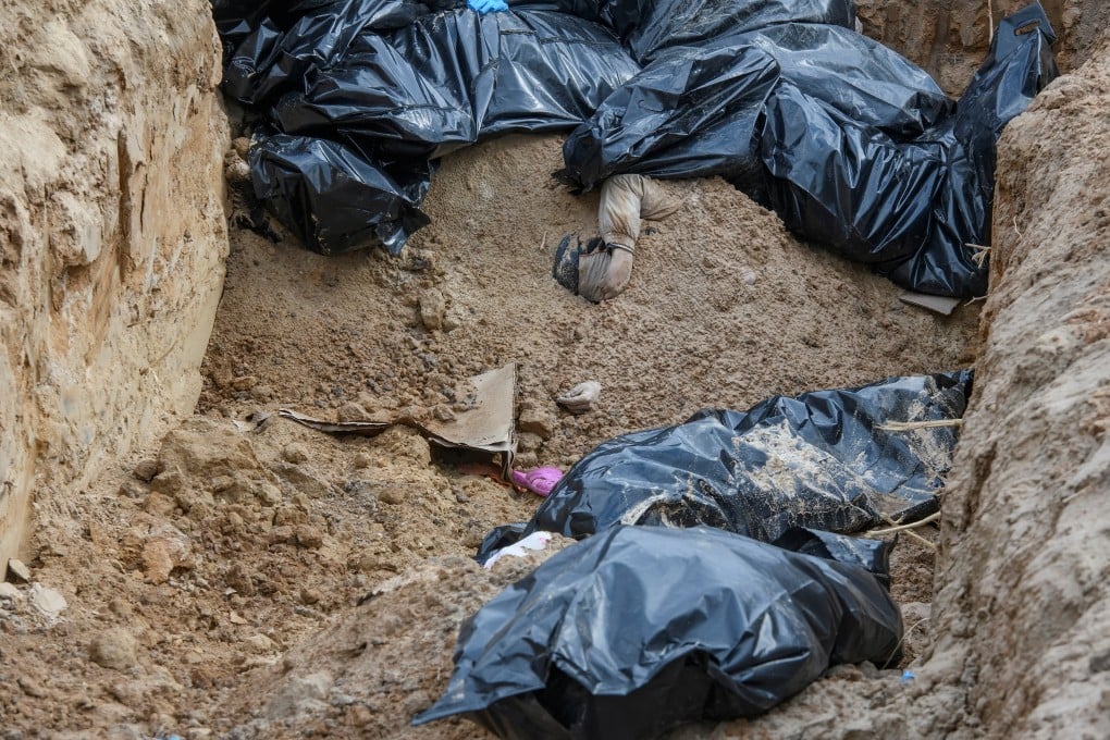 Bodies of civilians who local residents say were killed by Russian soldiers, in a mass grave in Bucha, near Kyiv, Ukraine, on Monday. Photo: Reuters
