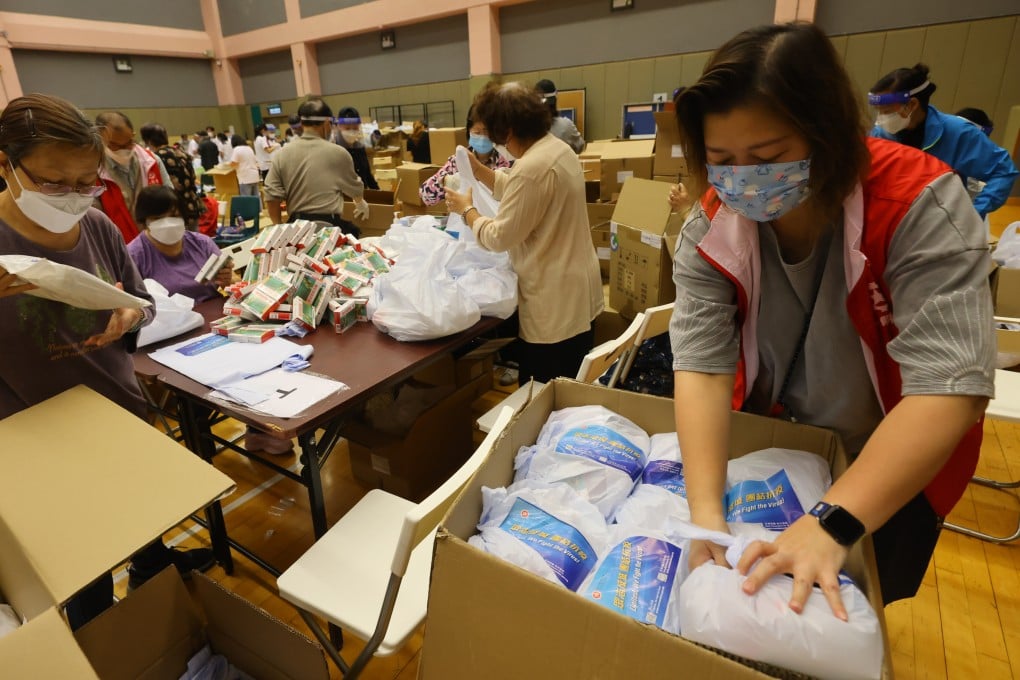 Volunteers pack anti-epidemic supply kits to be used in a mass at-home testing exercise later this week. Photo: Dickson Lee