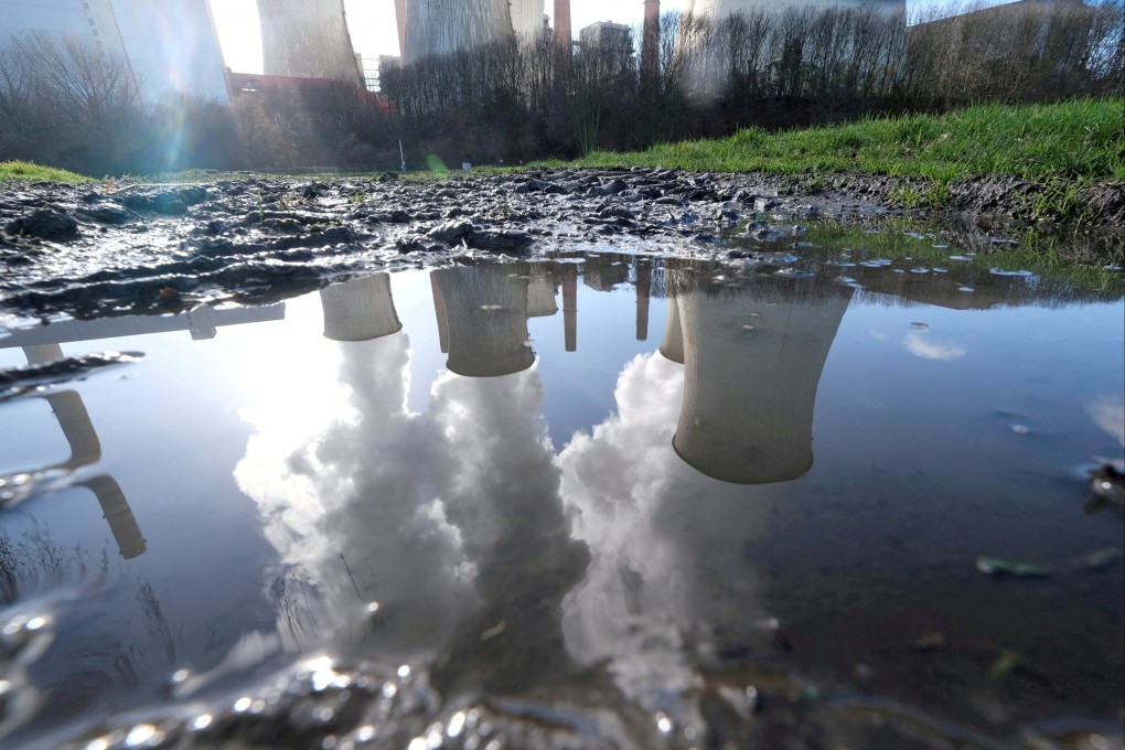 The lignite power plant complex of German energy supplier RWE is reflected in a large puddle in Neurath, northwest of Cologne, Germany, in 2020. Companies are hiring consultants to measure their carbon emissions as regulators require greater disclosures of climate risks. Photo: Reuters