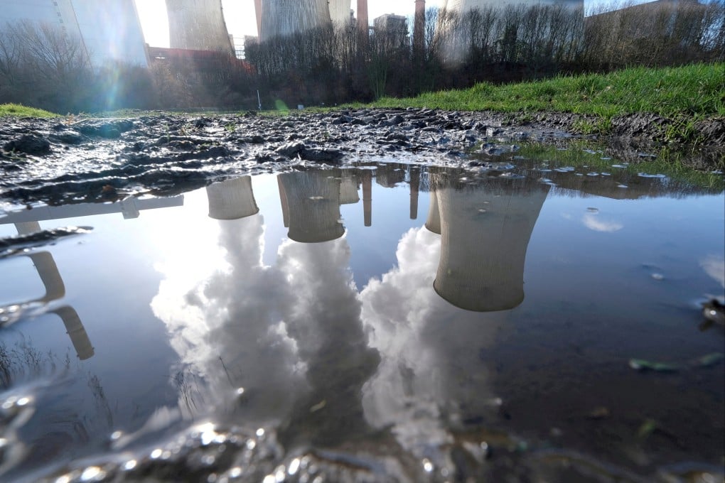 The lignite power plant complex of German energy supplier RWE is reflected in a large puddle in Neurath, northwest of Cologne, Germany, in 2020. Companies are hiring consultants to measure their carbon emissions as regulators require greater disclosures of climate risks. Photo: Reuters