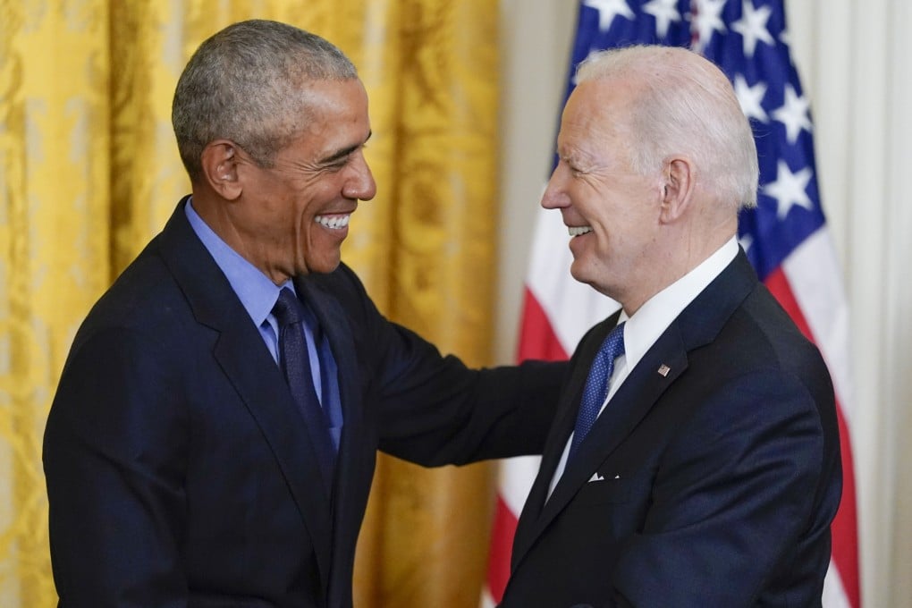 Former US president Barack Obama shakes hands with President Joe Biden at the White House on Tuesday. Photo: AP