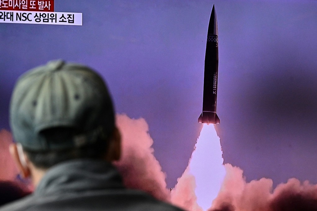 A man watches a news broadcast with file footage of a North Korean missile test at a railway station in Seoul in October 2021. Photo: TNS