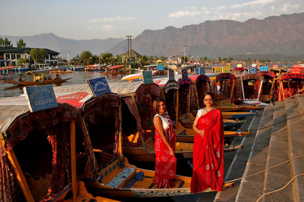Tourists pose on “shikara” boats on the banks of Dal Lake in Srinagar, Indian Kashmir. The region is seeing a tourism boom following a slump because of insecurity and the coronavirus pandemic. Photo: Reuters