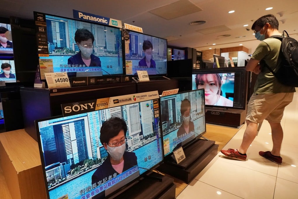 A man watches a live broadcast of Hong Kong Chief Executive Carrie Lam Cheng Yuet-ngor at an electronics store in Taikoo Shing in July 2020. Photo: Felix Wong