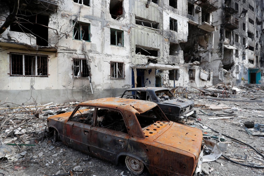 Remains of cars are seen in front of an apartment building destroyed during Ukraine-Russia conflict in the southern port city of Mariupol, Ukraine  on Sunday. Photo: Reuters